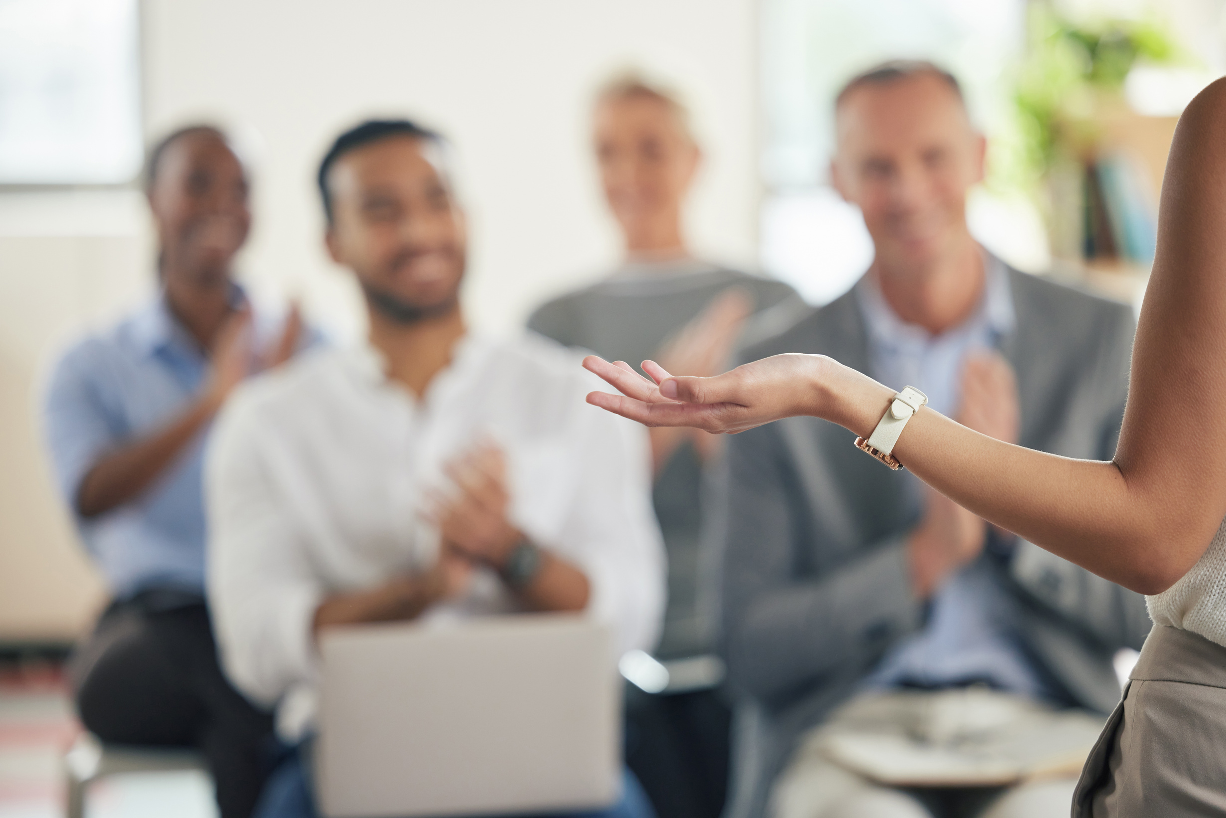 Shot of a group of business people applauding during a presentation